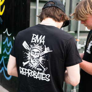 Man wearing black t shirt with bearded men adventures reprobates logo in white.