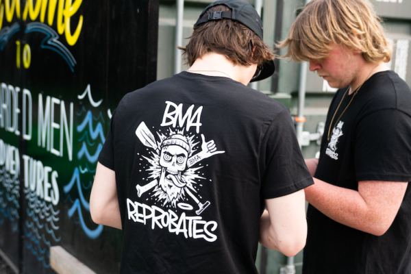 Man wearing black t shirt with bearded men adventures reprobates logo in white.