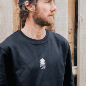 man wearing black sweatshirt and black 5 panel cap with bearded men adventures logo.